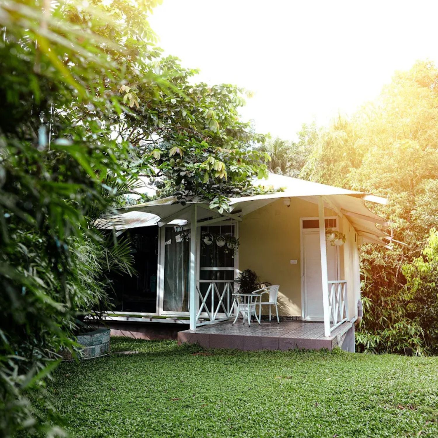 periyar river side accommodation - retreat inn kerala accommodation. retreat inn kerala ayurveda yoga resort Cozy riverside cottage surrounded by lush greenery at Retreat Inn Kerala, offering serene Periyar riverside accommodation for a peaceful and nature-connected stay.
